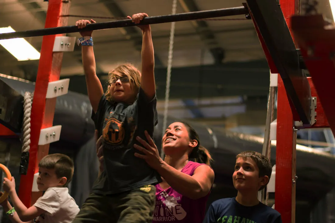 A camper on the salmon ladder during ninja camp time