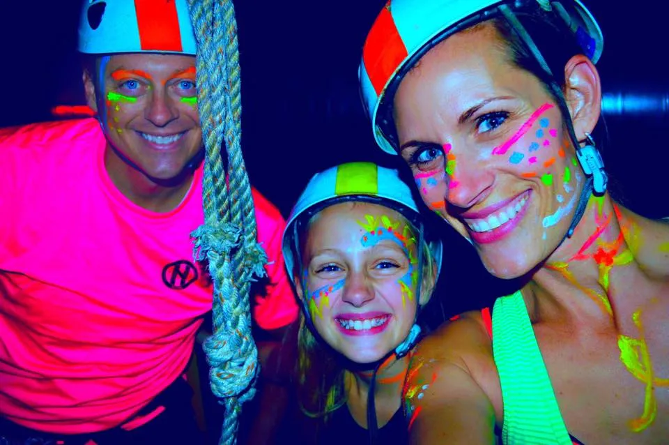 Families navigating suspended platforms on the ropes course