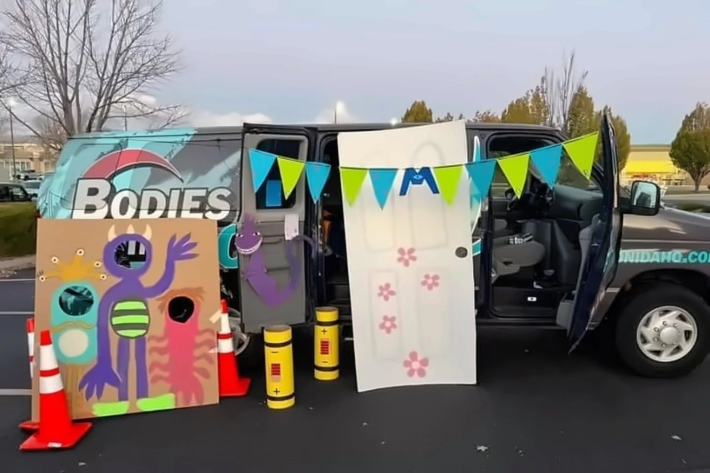 Bodies in Motion van decorated with a Monsters, Inc. theme, door and monster cutouts, at Trunk or Treat in Boise